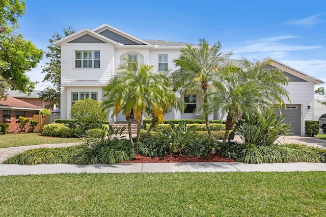 47 Martinique Ave, Tampa, FL 33606 - view of front facade featuring an attached garage, fence, and a front lawn