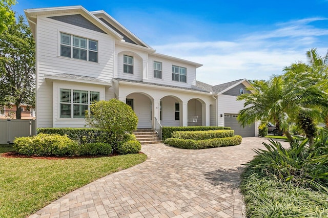 47 Martinique Ave, Tampa, FL 33606 - view of front facade with fence, decorative driveway, a front yard, covered porch, and a garage