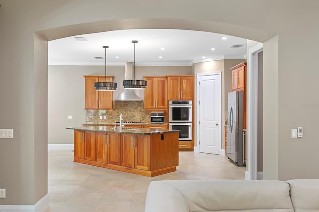 47 Martinique Ave, Tampa, FL 33606 - kitchen featuring backsplash, wall chimney exhaust hood, dark stone countertops, stainless steel appliances, and visible vents