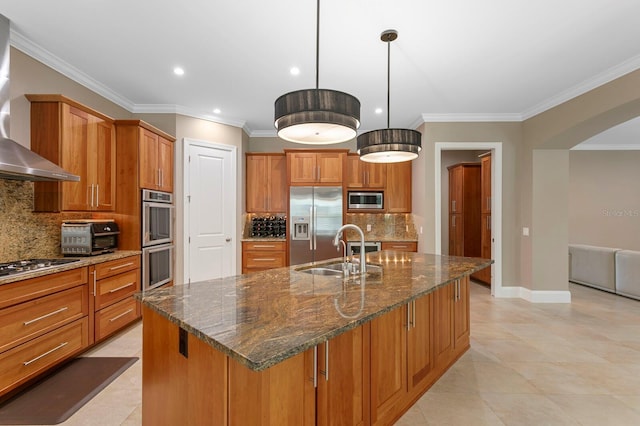 47 Martinique Ave, Tampa, FL 33606 - kitchen with a sink, arched walkways, wall chimney range hood, appliances with stainless steel finishes, and brown cabinets