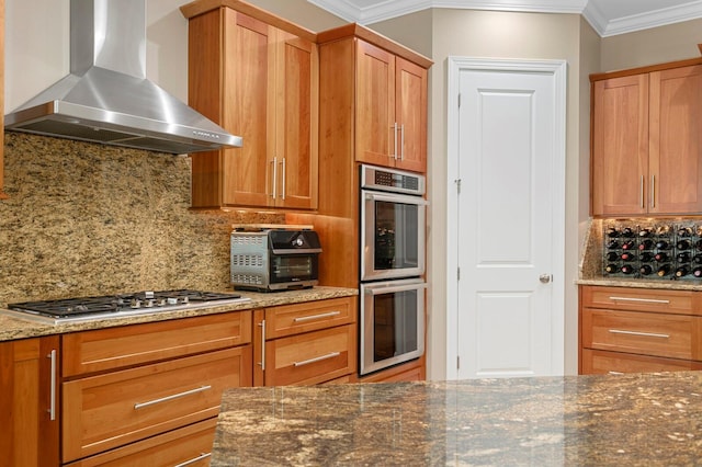 47 Martinique Ave, Tampa, FL 33606 - kitchen featuring wall chimney exhaust hood, dark stone countertops, stainless steel appliances, a toaster, and ornamental molding