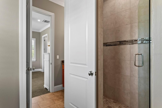 47 Martinique Ave, Tampa, FL 33606 - bathroom featuring tile patterned flooring, ornamental molding, baseboards, a shower stall, and visible vents
