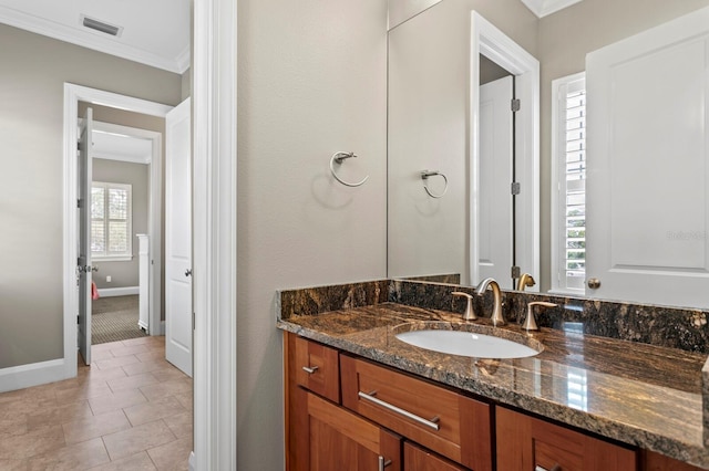 47 Martinique Ave, Tampa, FL 33606 - bathroom with crown molding, vanity, tile patterned flooring, baseboards, and visible vents