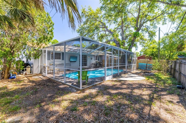 8766 91st St, Seminole, FL 33777 - back of property featuring a lanai, a patio area, a fenced backyard, and a fenced in pool