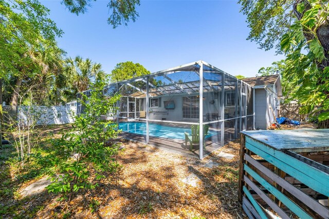 8766 91st St, Seminole, FL 33777 - view of pool featuring a fenced backyard, a fenced in pool, glass enclosure, and a deck