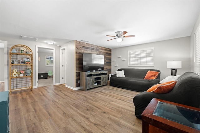 8766 91st St, Seminole, FL 33777 - living room featuring wood finished floors, baseboards, ceiling fan, and plenty of natural light