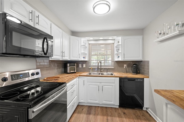 8766 91st St, Seminole, FL 33777 - kitchen featuring open shelves, wood finished floors, a sink, black appliances, and butcher block countertops