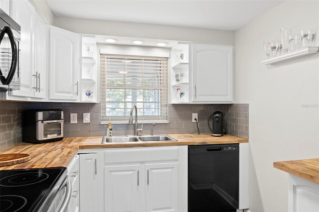 8766 91st St, Seminole, FL 33777 - kitchen with black dishwasher, wood counters, open shelves, and a sink