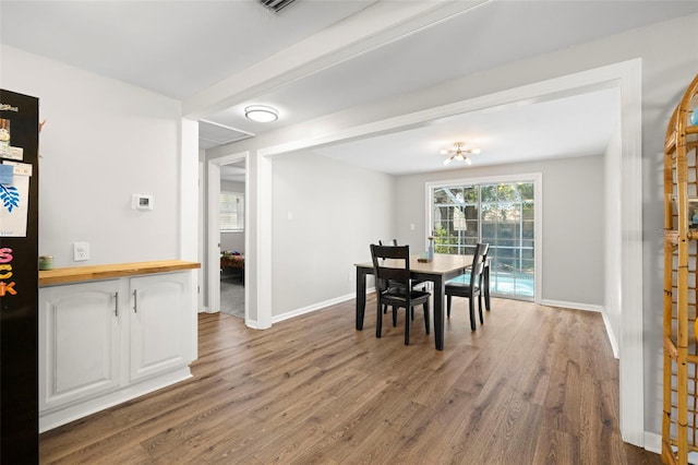 8766 91st St, Seminole, FL 33777 - dining space featuring baseboards and wood finished floors
