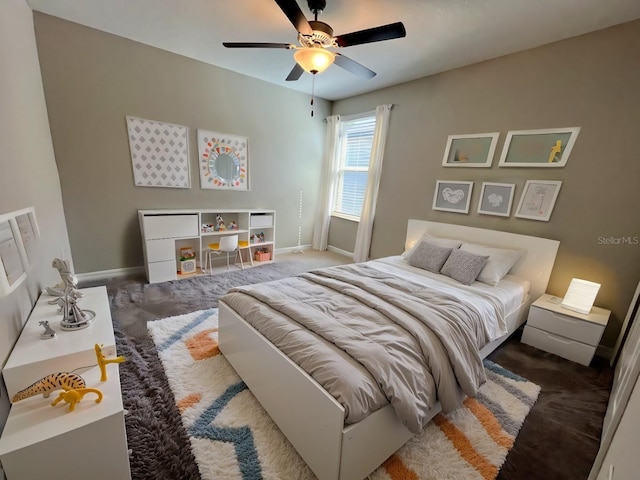 carpeted bedroom featuring a ceiling fan and baseboards