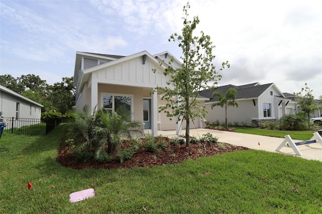 11884 Richmond Trl, Parrish, FL 34219 - view of front facade with board and batten siding, driveway, and a garage