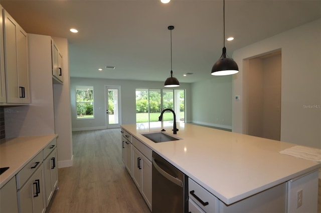 11884 Richmond Trl, Parrish, FL 34219 - kitchen featuring stainless steel dishwasher, light wood-style floors, recessed lighting, light countertops, and a kitchen island with sink
