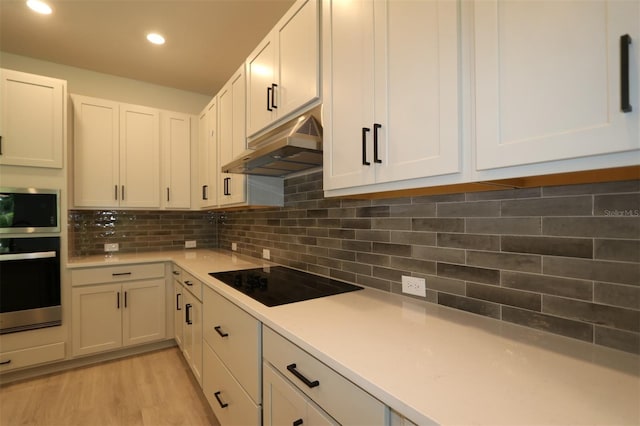 11884 Richmond Trl, Parrish, FL 34219 - kitchen featuring black electric cooktop, oven, under cabinet range hood, light countertops, and stainless steel microwave