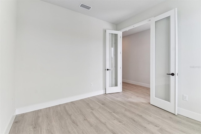 11884 Richmond Trl, Parrish, FL 34219 - empty room featuring french doors and wood finished floors