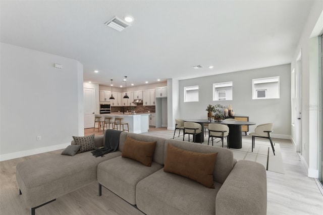 11884 Richmond Trl, Parrish, FL 34219 - living room featuring light wood finished floors and recessed lighting