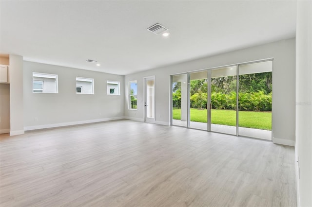 11884 Richmond Trl, Parrish, FL 34219 - unfurnished living room featuring plenty of natural light and light wood-type flooring