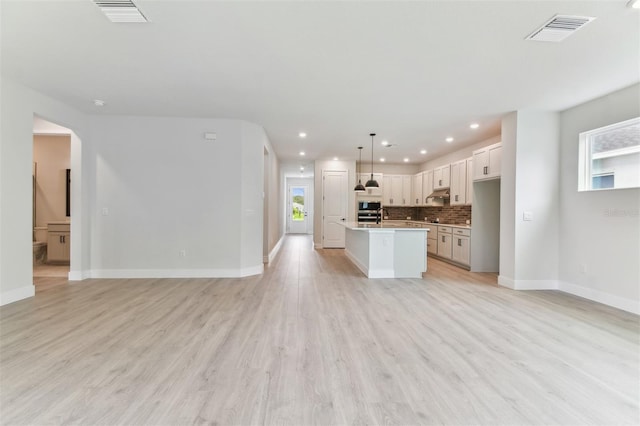 11884 Richmond Trl, Parrish, FL 34219 - unfurnished living room with plenty of natural light, recessed lighting, and light wood finished floors