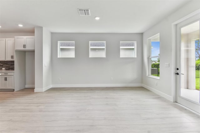 11884 Richmond Trl, Parrish, FL 34219 - unfurnished living room with light wood-style floors and recessed lighting