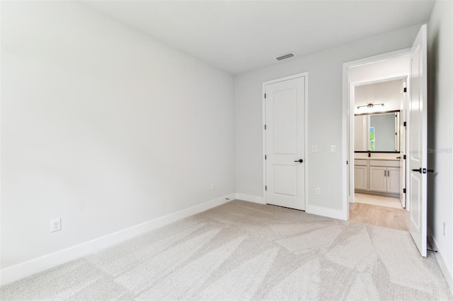 11884 Richmond Trl, Parrish, FL 34219 - unfurnished bedroom with light carpet and ensuite bathroom