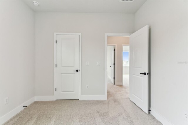 11884 Richmond Trl, Parrish, FL 34219 - unfurnished bedroom with light carpet and baseboards