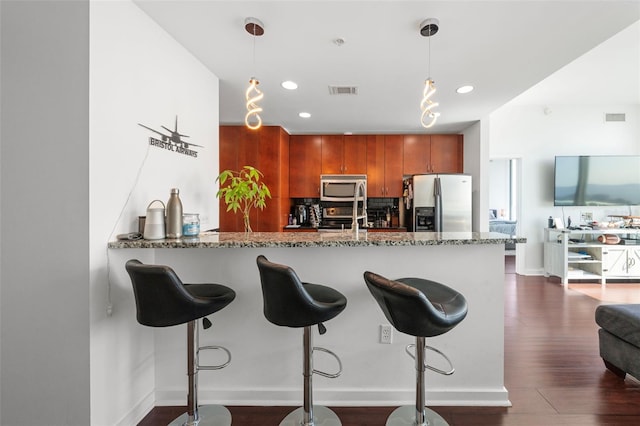 777 N Ashley Dr Unit 2610, Tampa, FL 33602 - kitchen featuring stone counters, dark wood-style floors, visible vents, a peninsula, and appliances with stainless steel finishes