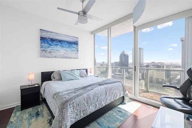 777 N Ashley Dr Unit 2610, Tampa, FL 33602 - bedroom featuring expansive windows, multiple windows, access to exterior, a city view, and wood finished floors