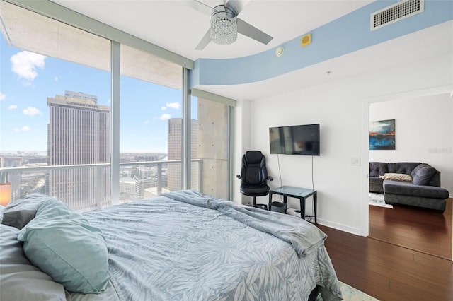 777 N Ashley Dr Unit 2610, Tampa, FL 33602 - bedroom featuring expansive windows, dark wood-style floors, baseboards, visible vents, and ceiling fan