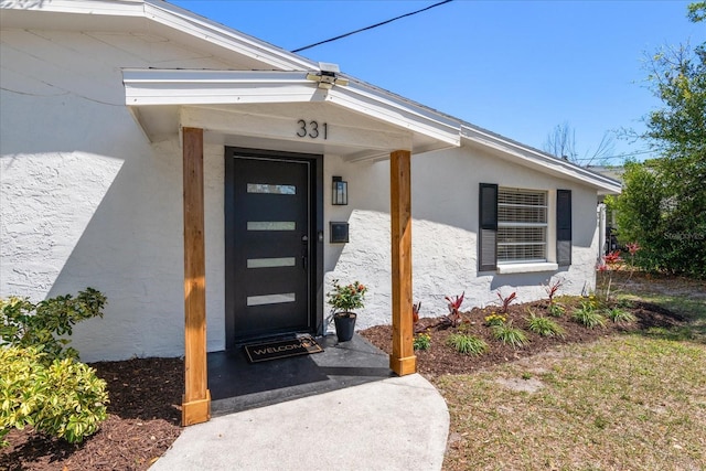331 Barbara Cir, Belleair, FL 33756 - view of exterior entry featuring stucco siding