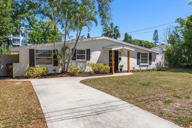 331 Barbara Cir, Belleair, FL 33756 - view of front of home featuring stucco siding and driveway