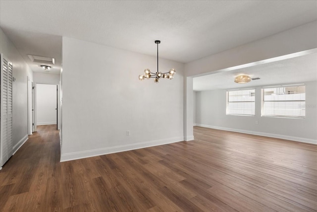 331 Barbara Cir, Belleair, FL 33756 - unfurnished dining area with wood finished floors, baseboards, and a chandelier