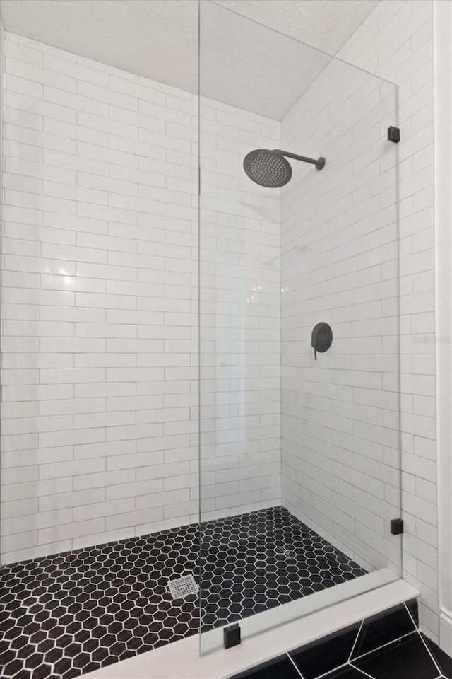 331 Barbara Cir, Belleair, FL 33756 - bathroom with a stall shower and a textured ceiling