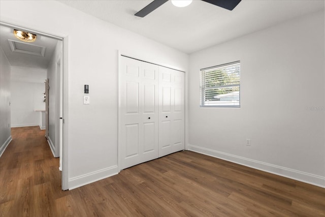331 Barbara Cir, Belleair, FL 33756 - unfurnished bedroom with dark wood-style flooring, baseboards, a closet, ceiling fan, and attic access