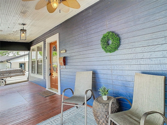 deck featuring covered porch and ceiling fan