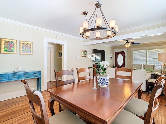 dining space with ceiling fan with notable chandelier, crown molding, light wood-style floors, and baseboards