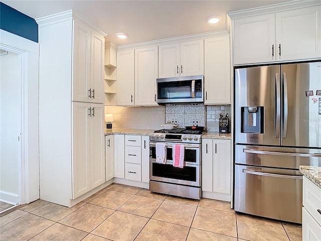 kitchen featuring white cabinets, stainless steel appliances, and tasteful backsplash