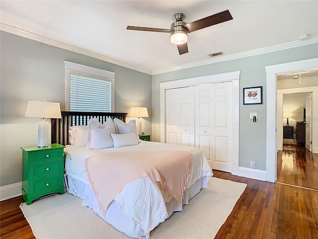 bedroom featuring a closet, visible vents, crown molding, and hardwood / wood-style flooring
