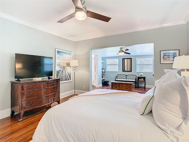 bedroom with a ceiling fan, ornamental molding, baseboards, and wood finished floors