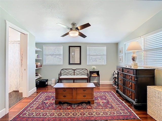 sitting room featuring baseboards, ceiling fan, and dark wood-style flooring