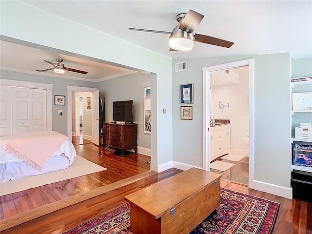 bedroom with crown molding, wood finished floors, baseboards, visible vents, and ceiling fan