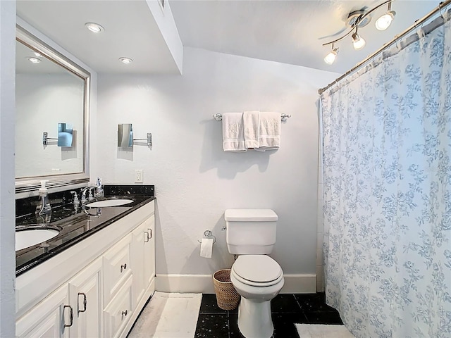full bath with tile patterned flooring, double vanity, a sink, and toilet