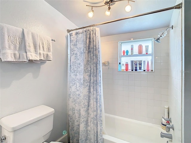 bathroom featuring toilet and shower / bath combo with shower curtain