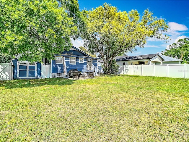 view of yard featuring a gate and a fenced backyard