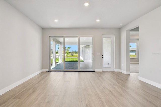 interior space featuring recessed lighting, light wood-type flooring, and baseboards