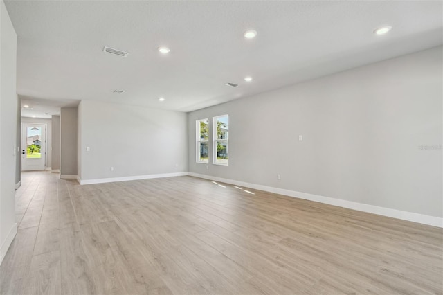 empty room with visible vents, baseboards, recessed lighting, and light wood-style floors