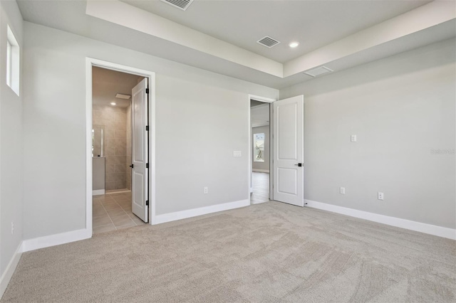 unfurnished bedroom featuring light carpet, baseboards, visible vents, and recessed lighting