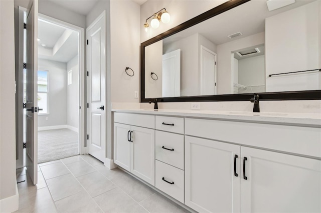 full bathroom featuring tile patterned floors, a sink, double vanity, baseboards, and visible vents
