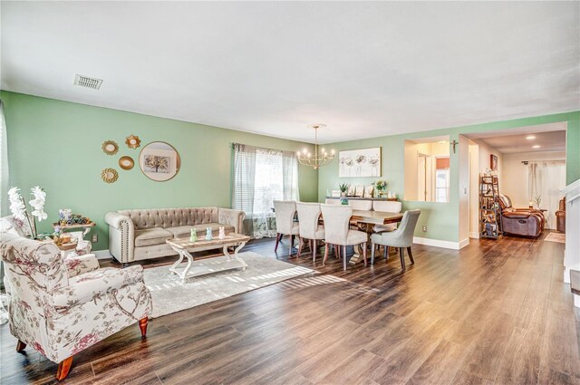 16755 Sunrise Vista Dr, Clermont, FL 34714 - living area featuring baseboards, a notable chandelier, visible vents, and wood finished floors
