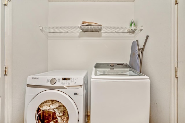 16755 Sunrise Vista Dr, Clermont, FL 34714 - washroom with washing machine and clothes dryer and laundry area