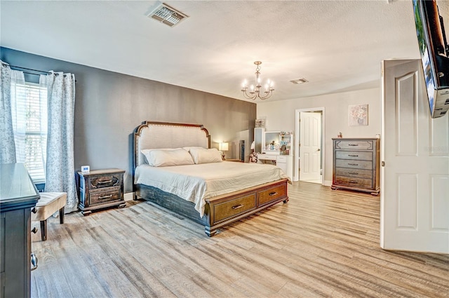 16755 Sunrise Vista Dr, Clermont, FL 34714 - bedroom with baseboards, light wood-style flooring, visible vents, and an inviting chandelier