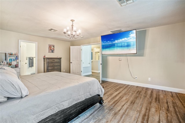 16755 Sunrise Vista Dr, Clermont, FL 34714 - bedroom with wood finished floors, baseboards, a chandelier, and visible vents